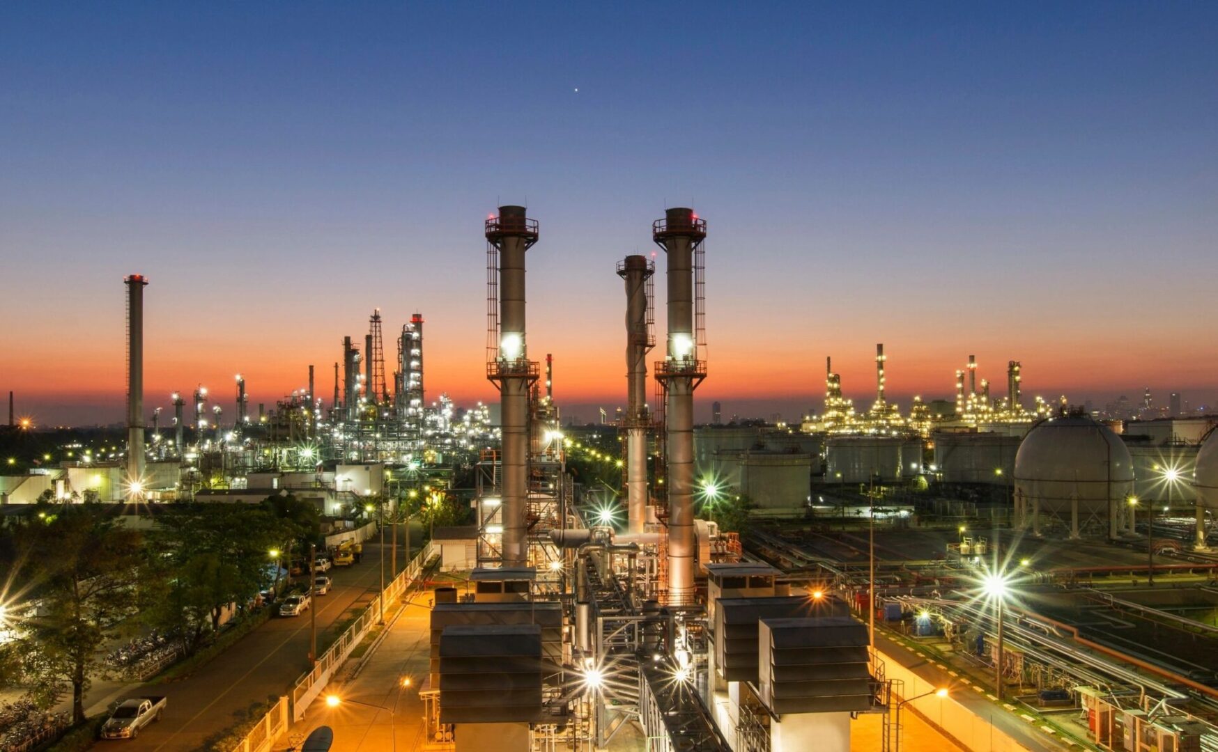 A large oil refinery with lights on at night.